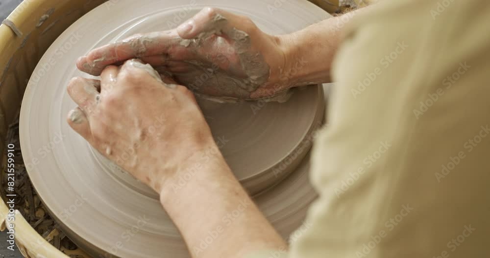 Close-Up of Hands Shaping Clay on Pottery Wheel in Artisan Workshop Close-Up of Hands Shaping Clay on Pottery Wheel in Artisan Workshop