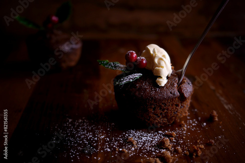 Mini Christmas plum pudding with dollop of cream. Horizontal orientation with negative copy space. photo