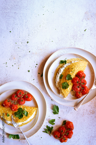 Gluten Free Crepes with Herb Ricotta and Roasted Truss Tomatoes. Negative copy space. photo