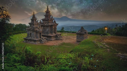 Gedongsongo temple at the night with milkyway on the sky full of stars.  photo