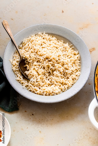  brown basmati rice with a spoon in a white bowl