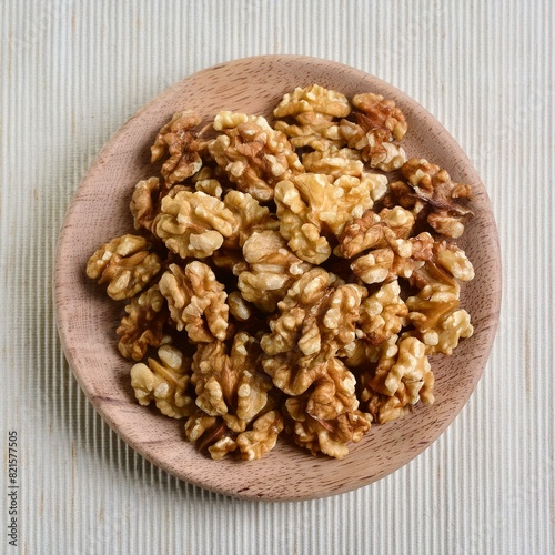 Close-Up: Walnut Kernels on Wooden Plate from Above