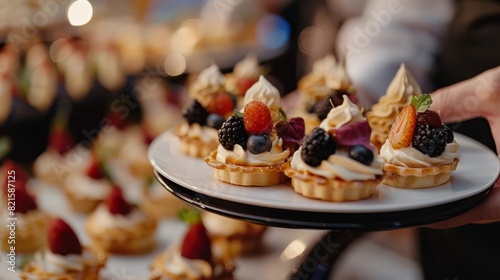 gourmet finger food desserts served by waiter at cocktail party catering closeup