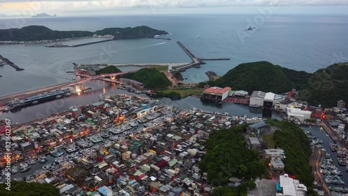 HYPERLAPSEAerial hyperlapse above Nanfang'ao Harbor, a fishing village in Yilan County northeast to Taipei, Taiwan, with boats navigating and parking in the seaport and Guishan Island located _0001_78 photo