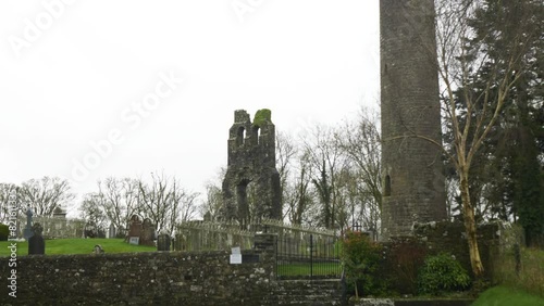 Preserved 9th Century Church Round Tower In Donaghmore Cemetery, Navan, County Meath, Ireland. Tilt-up Shot photo