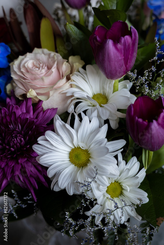 Close up texture background of an indoor florist   s bouquet arrangement containing colorful flowers  with defocused background