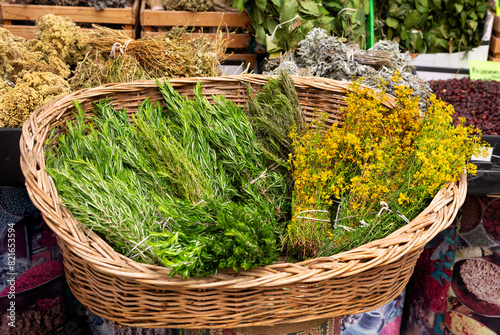 Basket of rosemary herbs with yellow flowers at the Kemeralti Market in Izmir, Turkey