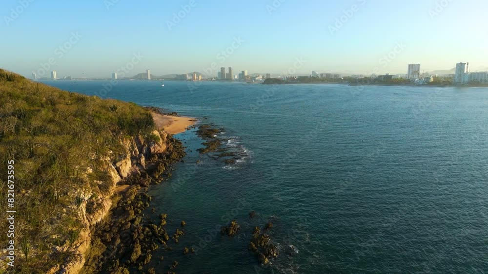 Aerial video of Mazatlán at dawn from Isla de los Venados, highlighting the vast ocean, morning currents, and numerous birds flying along the rocky island's picturesque coastline Aerial video of Mazatlán at dawn from Isla de los Venados, highlighting the vast ocean, morning currents, and numerous birds flying along the rocky island's picturesque coastline