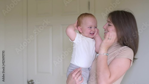 A heartwarming moment unfolds as a mother plays peekaboo with her delighted toddler, fostering joy and emotional bonding in a light-filled home environment.