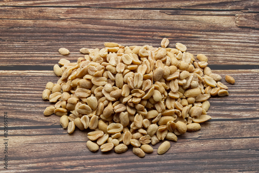 Pealed Peanuts isolated on wooden background Pealed Peanuts isolated on wooden background