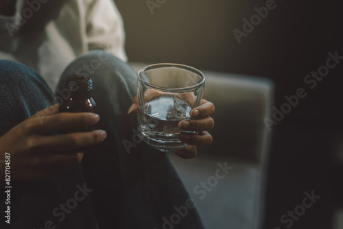 Upset woman frustrated by problem with work or relationships  sitting on couch  embracing knees  covered face in hand  feeling despair and anxiety  loneliness  having psychological trouble