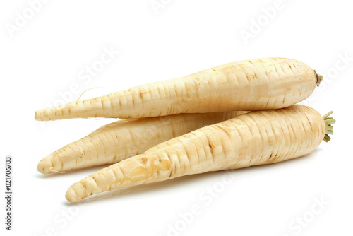 Fresh parsnip roots on a white background.