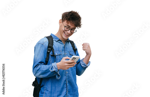 Grateful smart teen boy in jeans shirt received great News  in message smiles clenches fist like winner excited by passed exams against transparent background. Mockup, success, happy people. photo