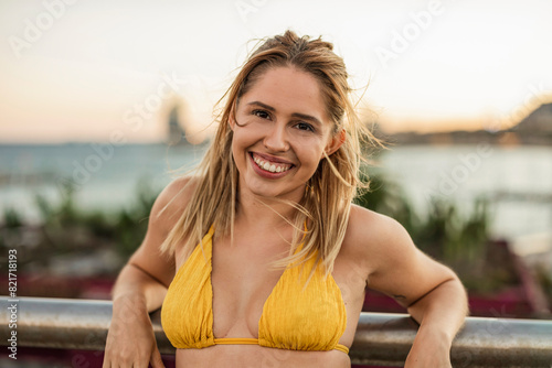 Smiling Woman in Yellow Bikini at Sunset Beach