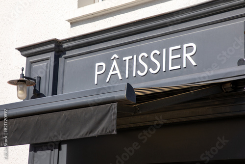patissier text french and sign on shop facade means pastry entrance boutique in france © OceanProd
