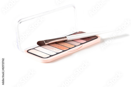 Neutral nude colour eyeshadow palette with professional brush at white background for make up