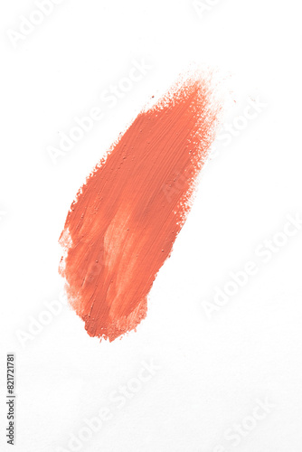Peach lipstick or blush smear stroke on white background, abstract cosmetic make up sample