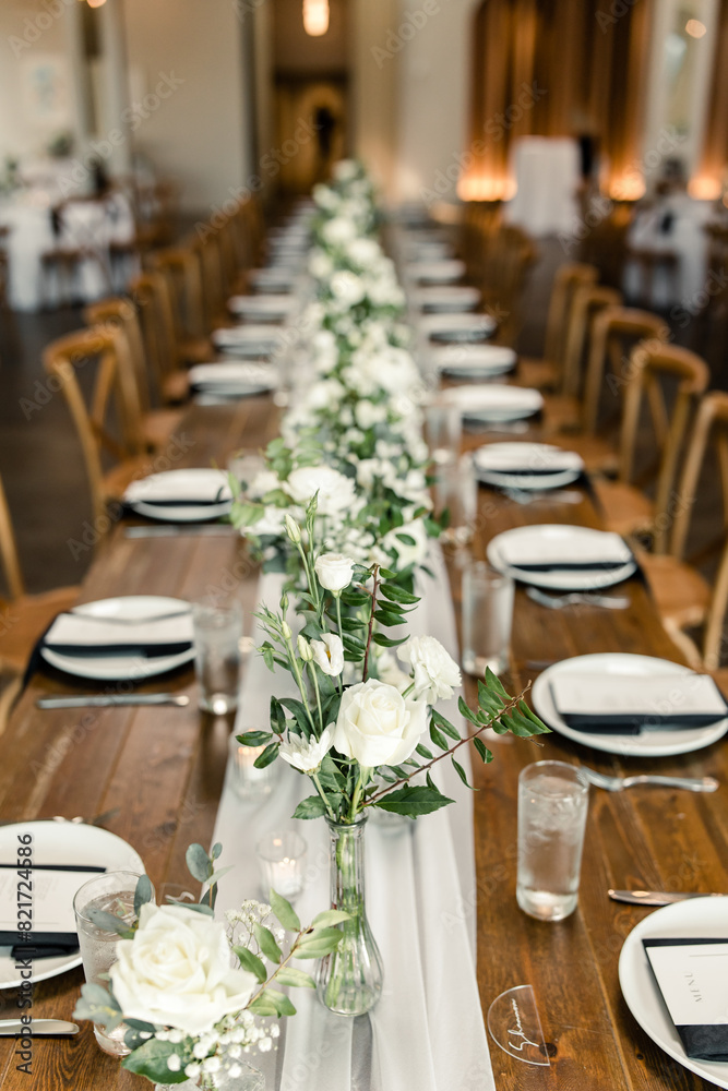 Elegant wedding reception table with white floral centerpieces