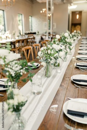 Long reception table with elegant white floral decor © Cavan