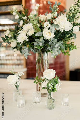 White floral arrangements on elegant bar setting