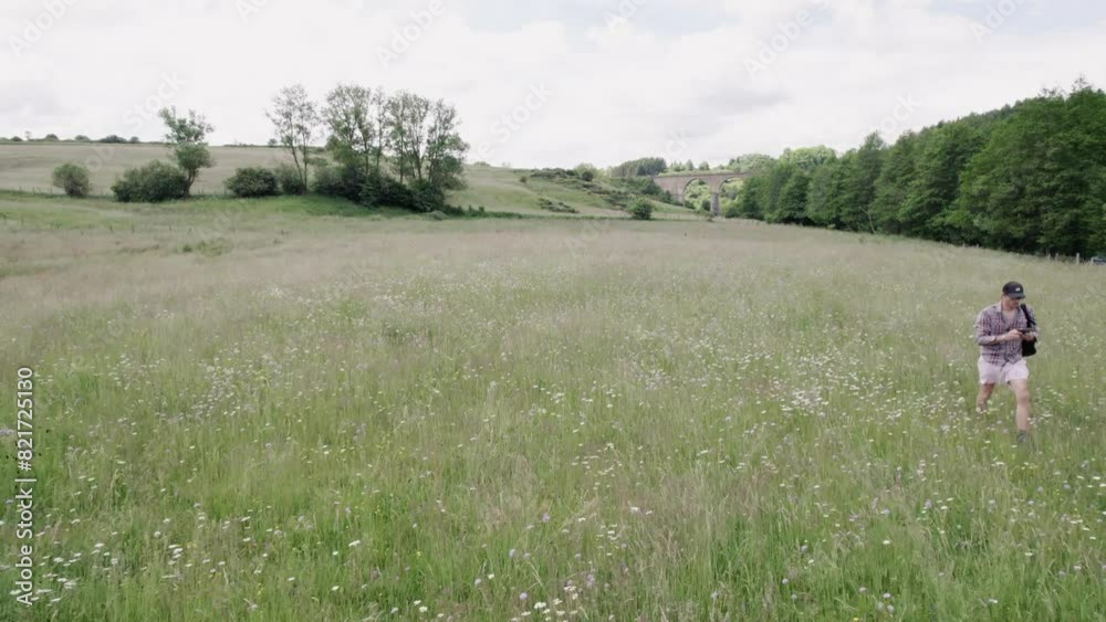 Man With Backpack Running On The Countryside Spring Fields Man With Backpack Running On The Countryside Spring Fields