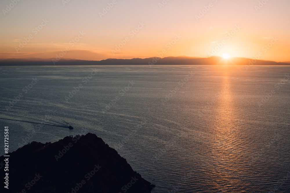 Sunset over Elba Island with Corsica in the distance, Italy