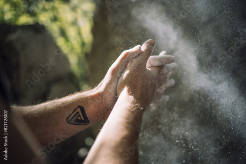 Climber preparing hands with chalk near Lake Garda, Italy