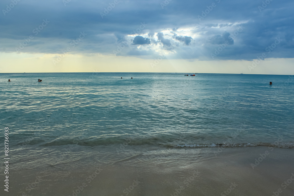 Karon beach in Thailand during the sunset with cloudy sky and copy space Karon beach in Thailand during the sunset with cloudy sky and copy space