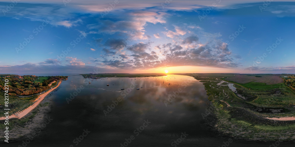 A 360 degree aerial view of a spectacular sunset over the River Deben at Bawdsey Beach in Suffolk, UK A 360 degree aerial view of a spectacular sunset over the River Deben at Bawdsey Beach in Suffolk, UK