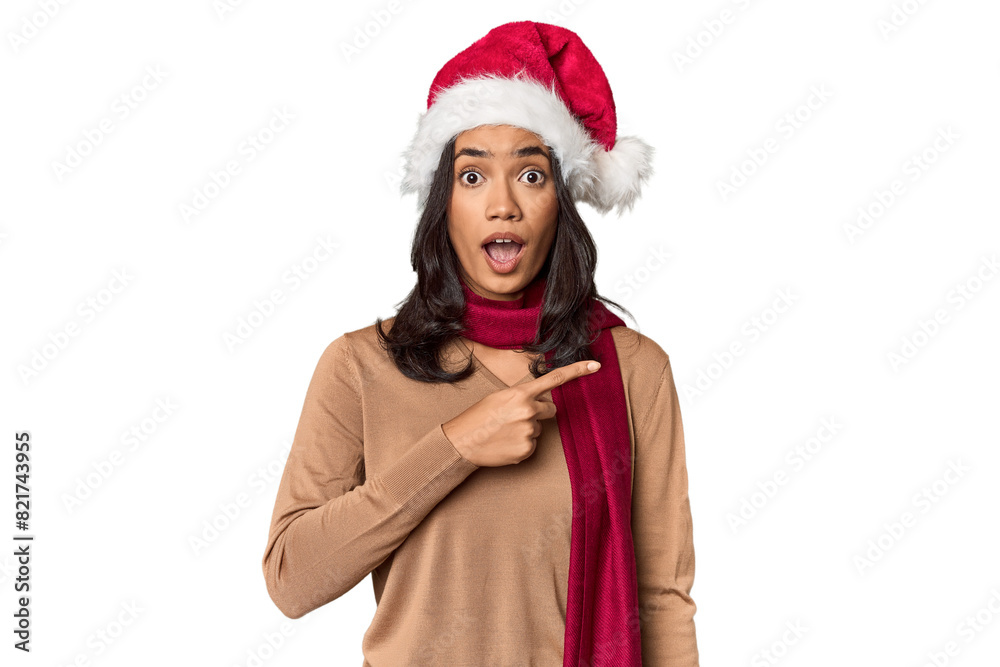 Filipino in Christmas attire and Santa hat pointing to the side Filipino in Christmas attire and Santa hat pointing to the side