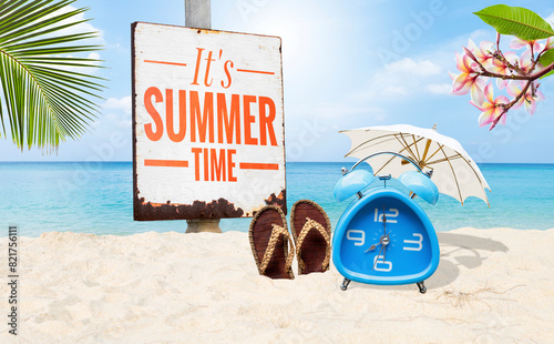 It's summer time sign with alram clock on tropical beach, summer outdoor day light photo