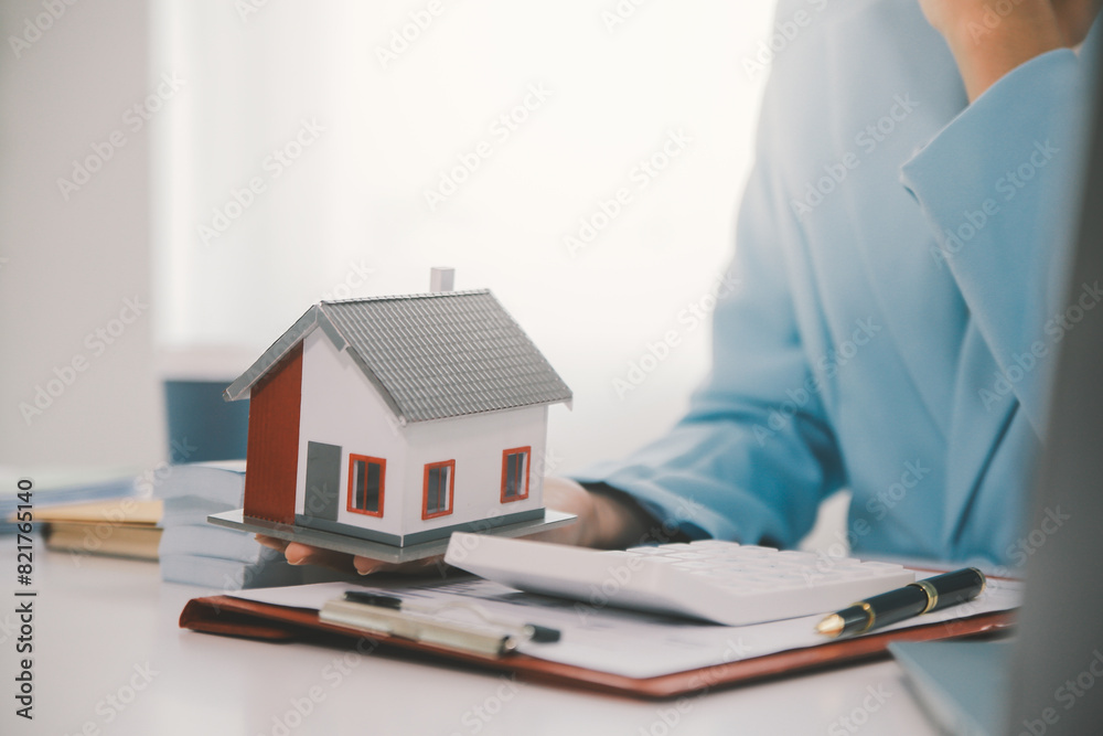 Real estate agent talked about the terms of the home purchase agreement and asked the customer to sign the documents to make the contract legally, Home sales and home insurance concept. Real estate agent talked about the terms of the home purchase agreement and asked the customer to sign the documents to make the contract legally, Home sales and home insurance concept.