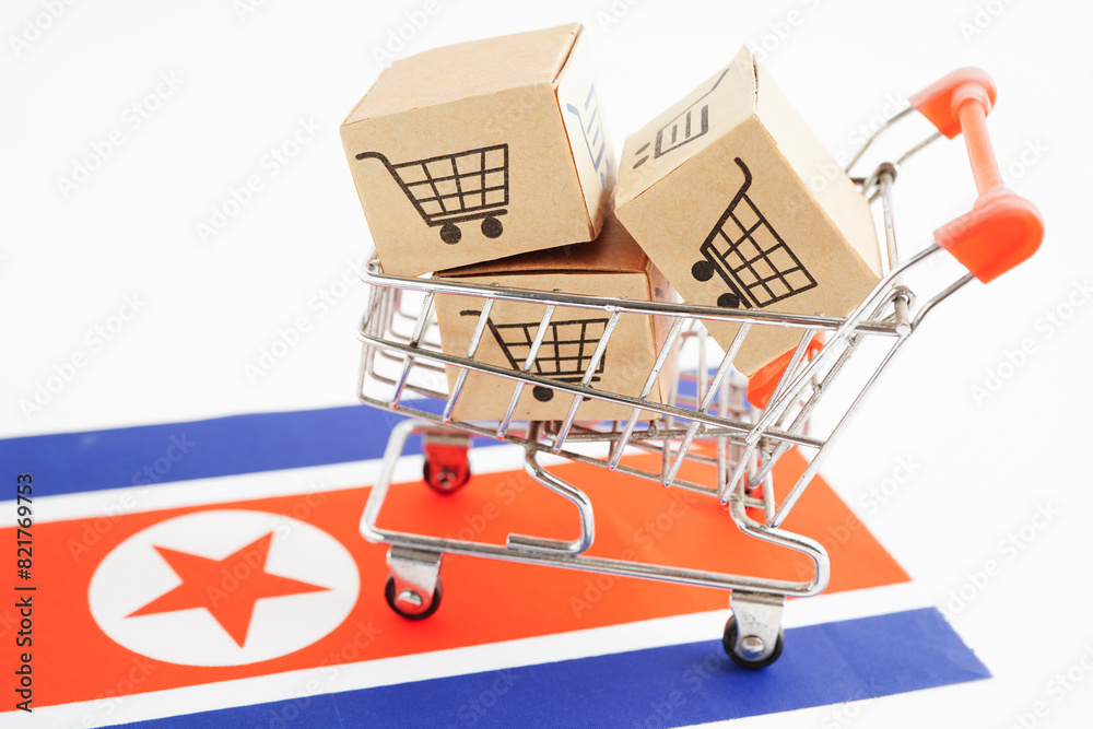 Online shopping, Shopping cart box on North Korea flag, import export, finance commerce.