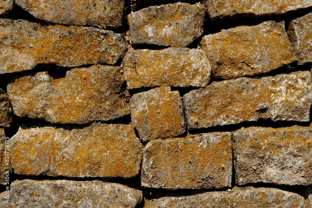 natural stone wall. box-shaped natural stone stacked into a natural stone wall. limestone, andesite, marble is often used for natural stone walls. good architectural element. natural stone wall. box-shaped natural stone stacked into a natural stone wall. limestone, andesite, marble is often used for natural stone walls. good architectural element.