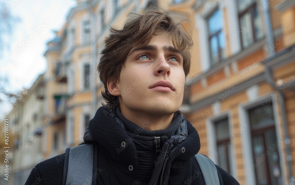 A young man standing confidently in front of a modern skyscraper A young man standing confidently in front of a modern skyscraper
