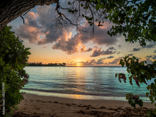 Hawaiian Kawela Bay Beach colorful Sunset Phase with silhouette palm trees photo