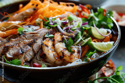 Grilled Shrimp and Beef Vermicelli Bowl with Fresh Vegetables, Herbs, and Lime Wedges