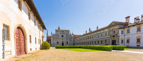 Certosa di Pavia monastery, historical monumental complex that includes a monastery and a sanctuary. green court and a church.The Ducale Palace on the right,Pavia,Italy. photo