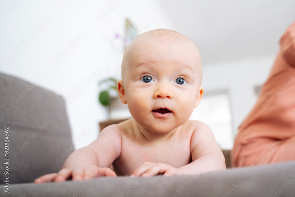 Cute shirtless baby boy lying on sofa at home Cute shirtless baby boy lying on sofa at home