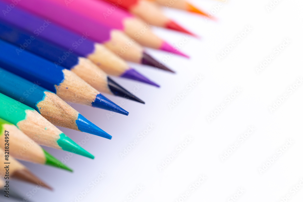Colored pencils arranged beautifully by color. Taken at a close distance Isolated on a white background Leave space for text to create a background template.