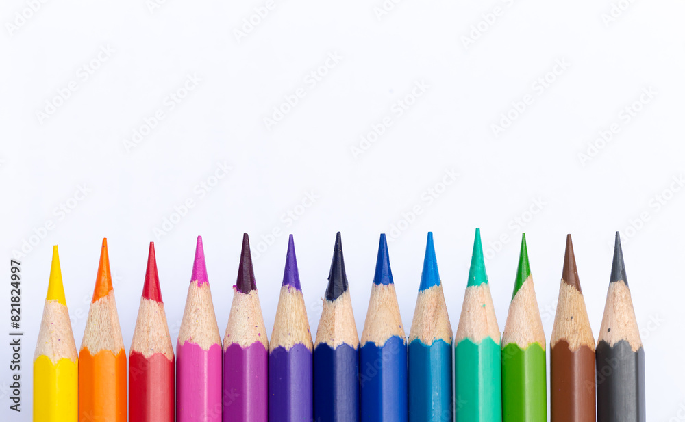 Colored pencils arranged in a straight line on a white paper background. It has bright colors and plenty of space for text. Suitable for making templates or backgrounds. Colored pencils arranged in a straight line on a white paper background. It has bright colors and plenty of space for text. Suitable for making templates or backgrounds.