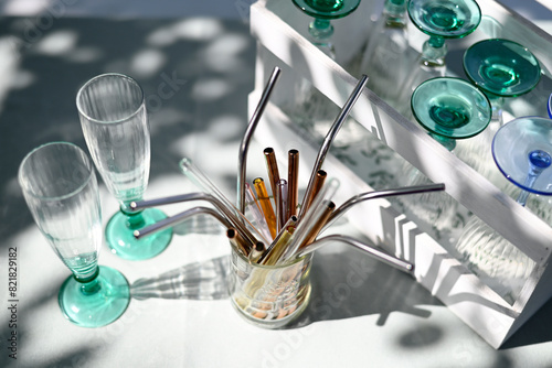 Various glasses and metal drinking straws photo