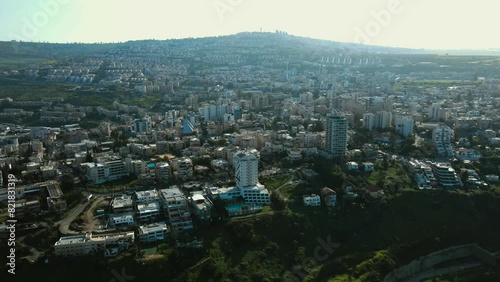 Drone shot of tiberias city.
The city of Lower Tiberias is close to the Sea of Galilee.
You can see the hotels and the city spread out on the side of the mountain. photo