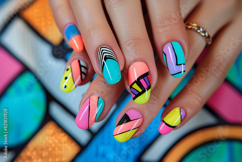 close up manicure with abstract graphic colorful nail art design rounded nails on hands, on colorful painted colorblock background © Ricky
