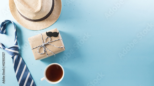 Happy Fathers Day background concept with gift box, decorated bow tie, necktie and mustache on bright pastel background.