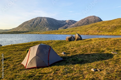 Camping tent by Lough Inagh, Connemara national park, county Galway, Ireland, lakeside landscape scenery with mountains in background, scenic nature wallpaper