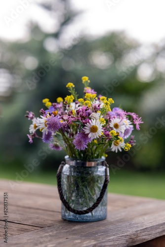 Garden Time - a bunch of wild flowers standing on a garden table