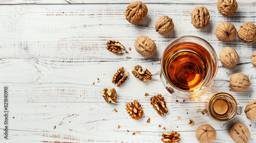 Delicious liqueur and fresh walnuts on white wooden table