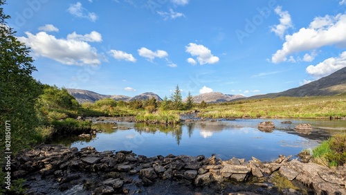 Beautiful landscape scenery, river with mountains and pine trees reflection, nature background Derryclare natural reserve at Connemara national park, county Galway, Ireland, wallpaper