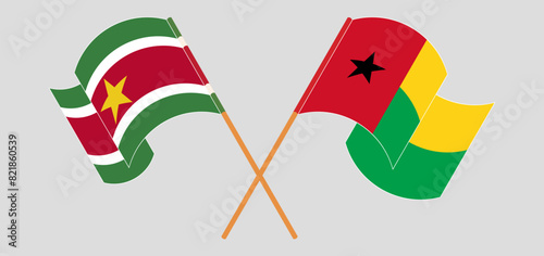 Crossed and waving flags of Suriname and Guinea-Bissau